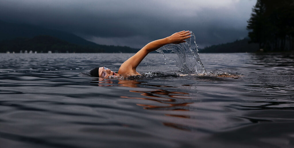 a woman swimming in the outdoors